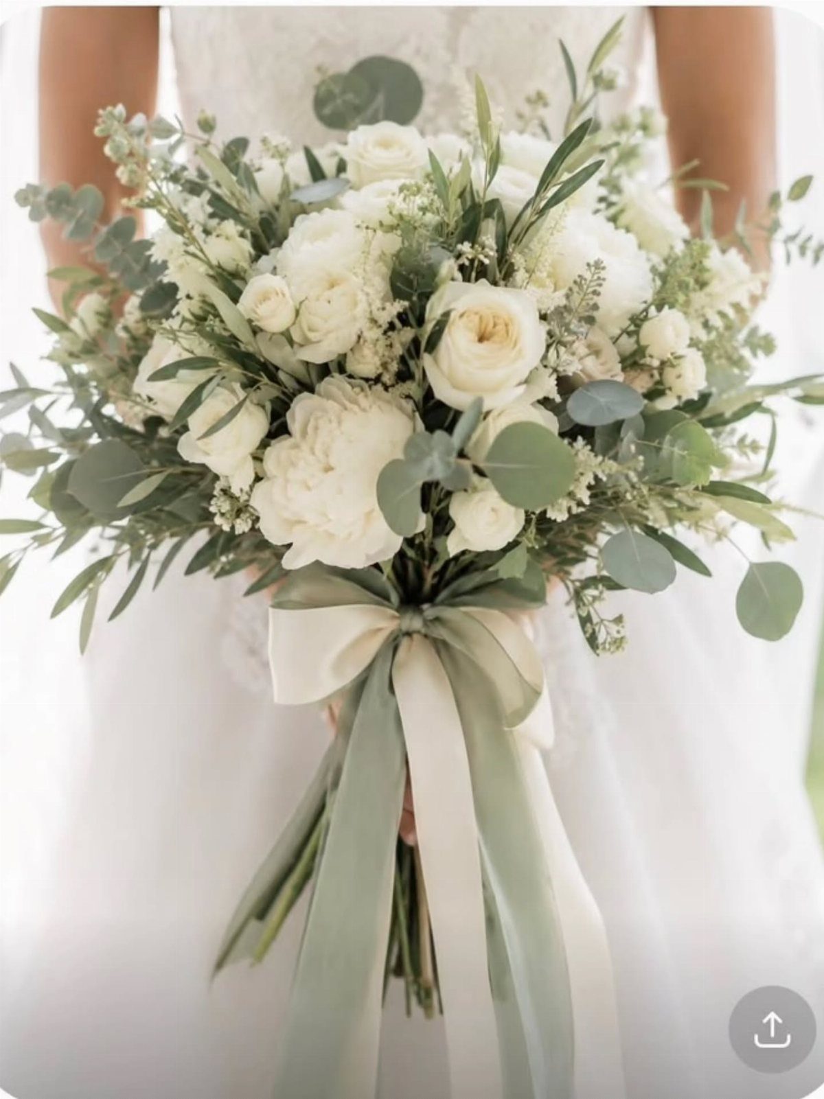 15 Boho Wedding Flowers and Ideas for the Free-Spirited Bride 13 A bridal bouquet of white roses and greenery tied with long sage green ribbons.