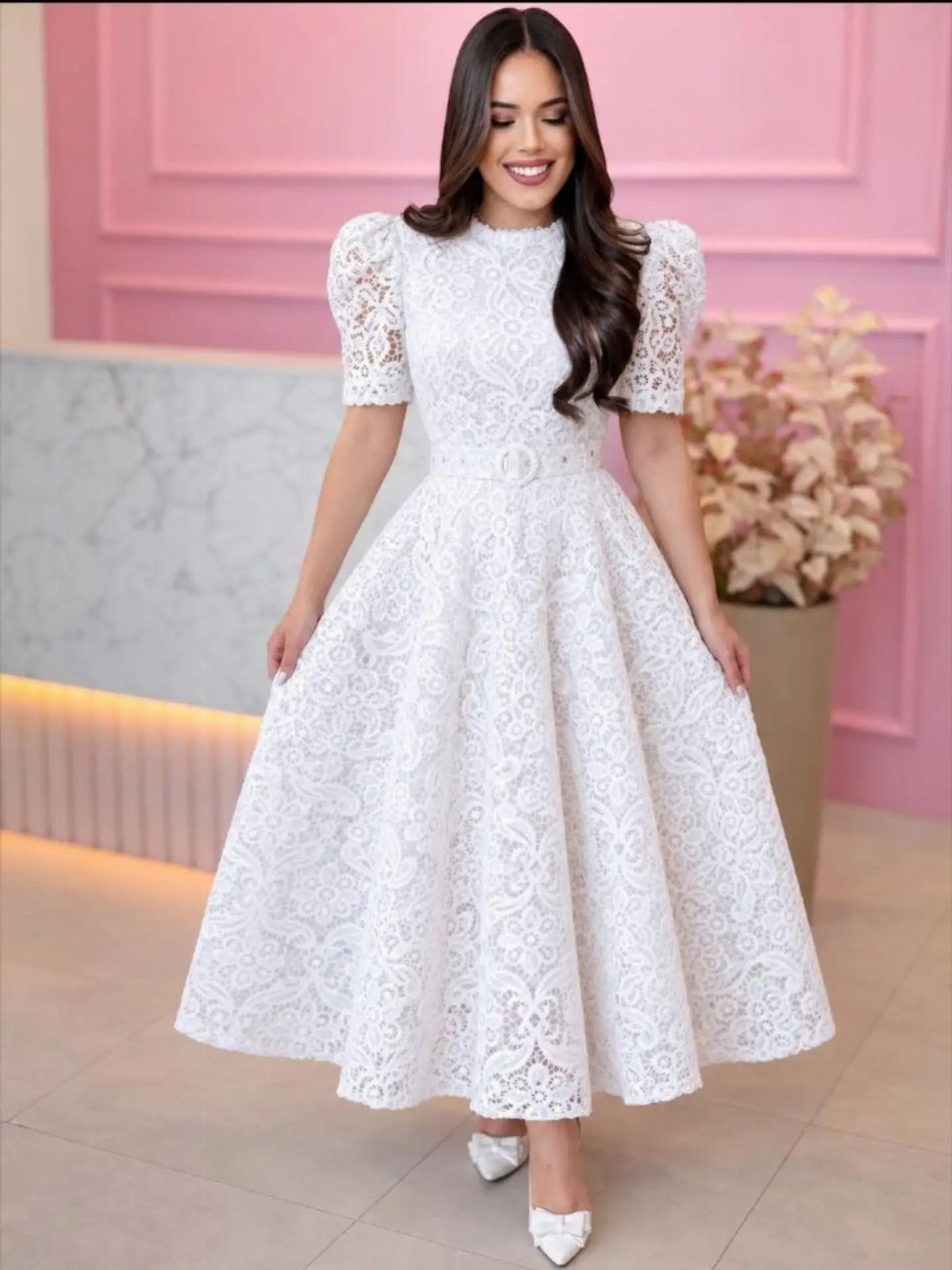 Church Wedding Dress: 10 Styles for the Ceremony 3 A smiling woman wearing a white lace midi dress with short puff sleeves.