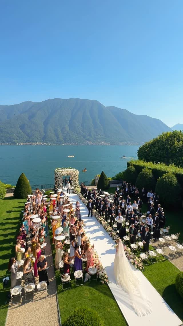 Mansion Wedding Venue Ideas: 17 Estate Settings for 2026 13 Wedding ceremony setup on a green lawn overlooking a lake and mountains with a white aisle runner.