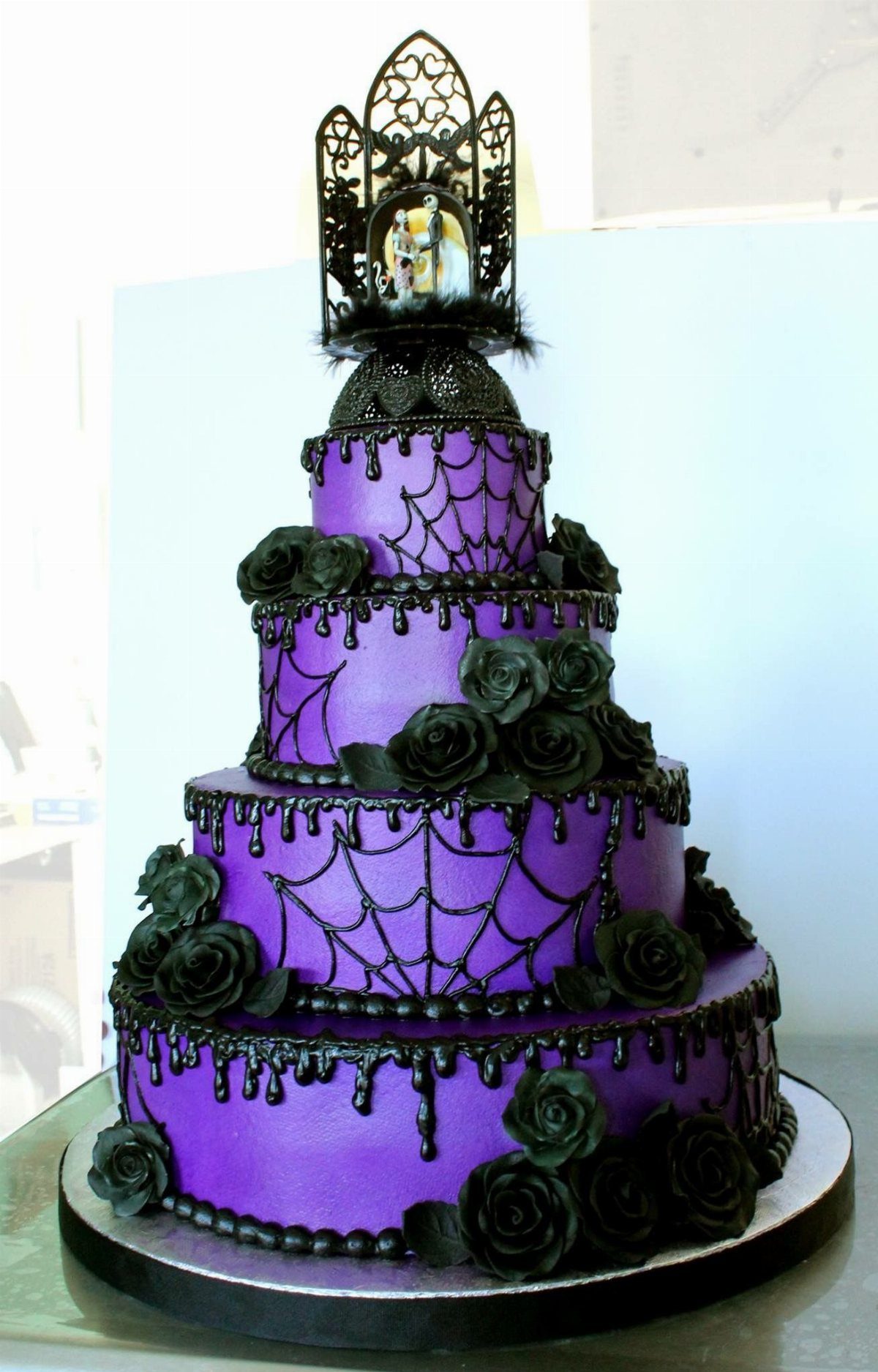 Purple and Black Wedding Theme: 8 Ideas That Actually Work 5 A four-tier purple wedding cake decorated with black spiderwebs, black roses, and black dripping icing.