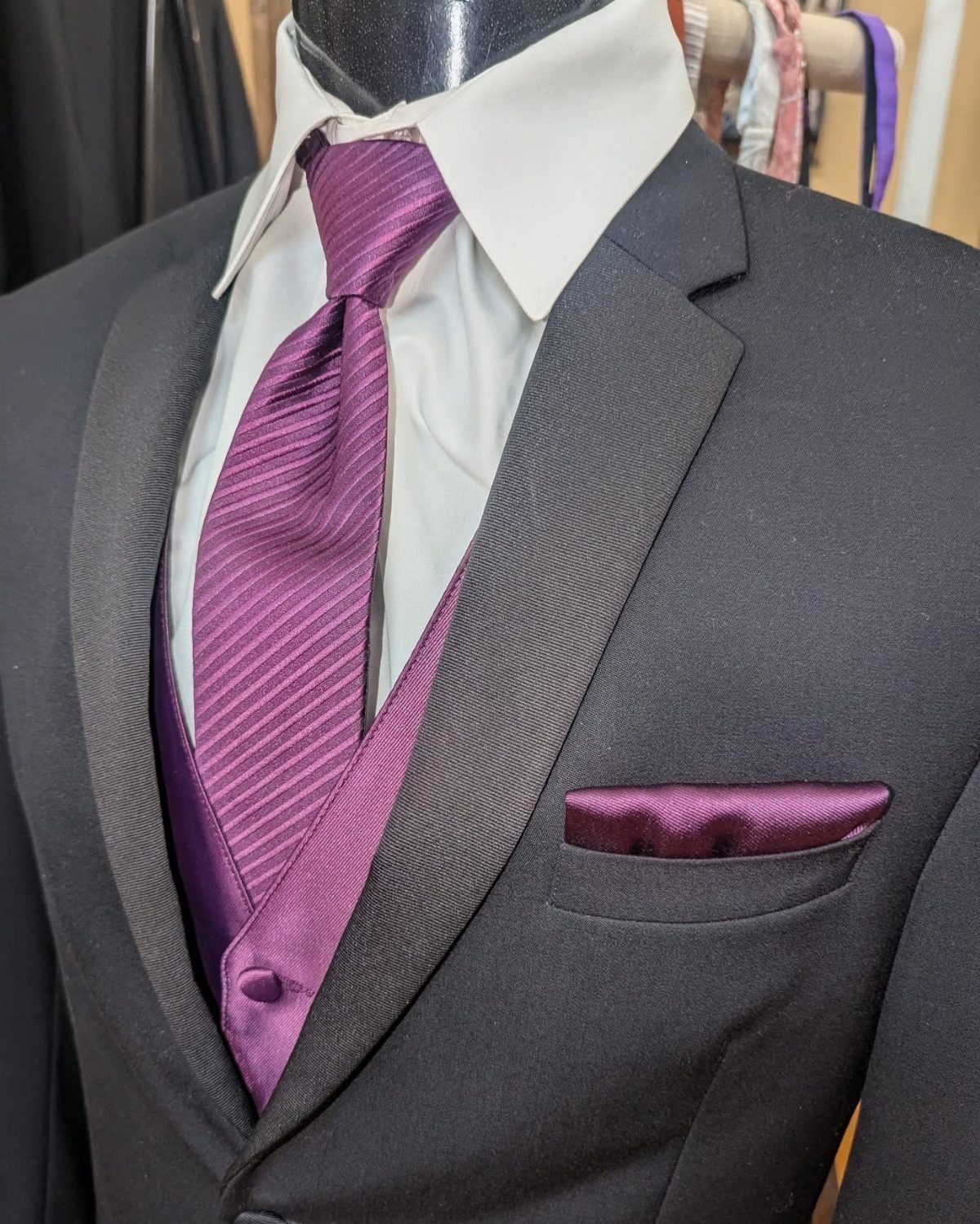 Purple and Black Wedding Theme: 8 Ideas That Actually Work 3 A black tuxedo featuring a purple waistcoat, striped purple tie, and matching purple pocket square.
