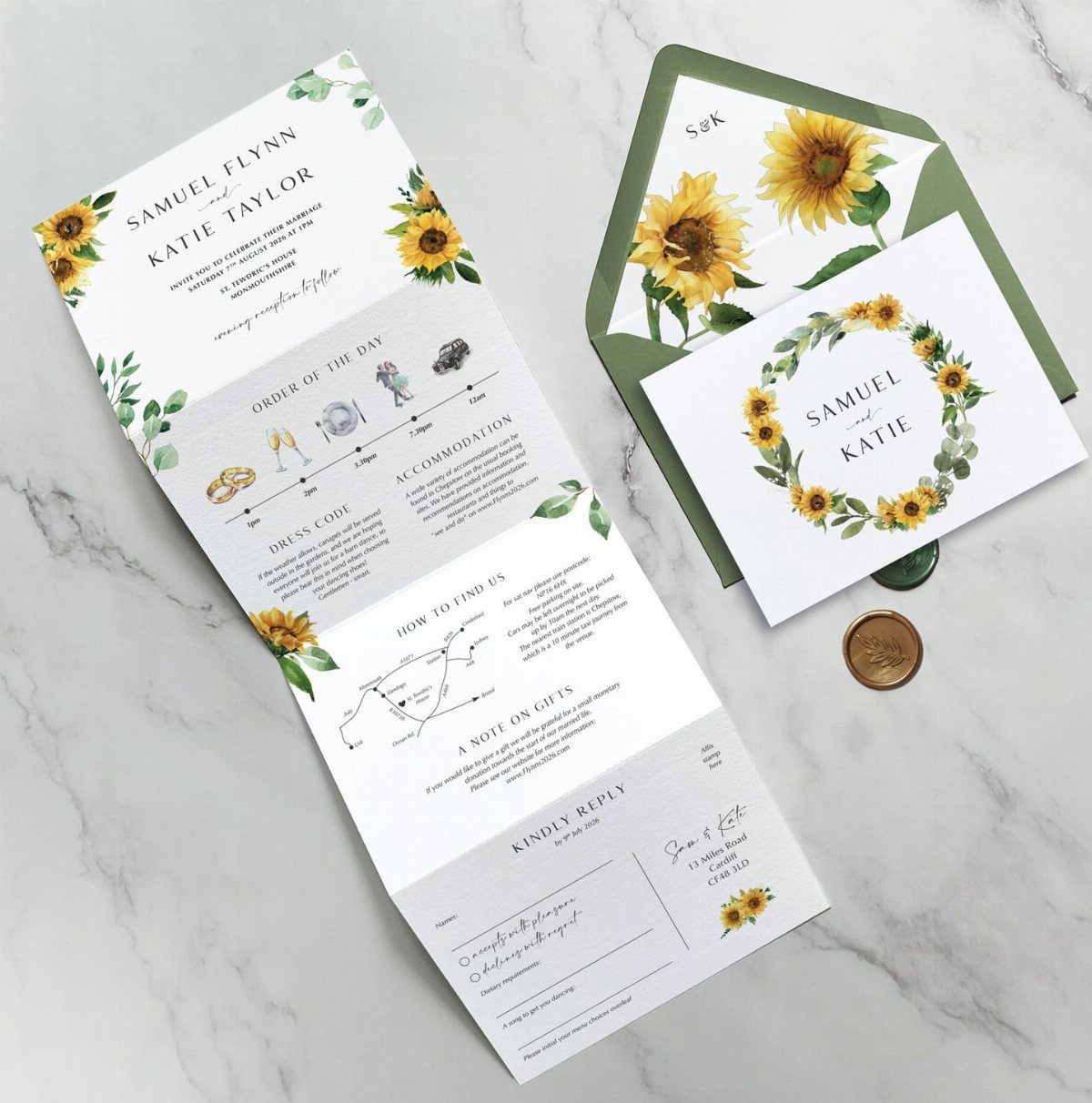 Sunflower wedding invitation and green envelope resting on a white marble surface.