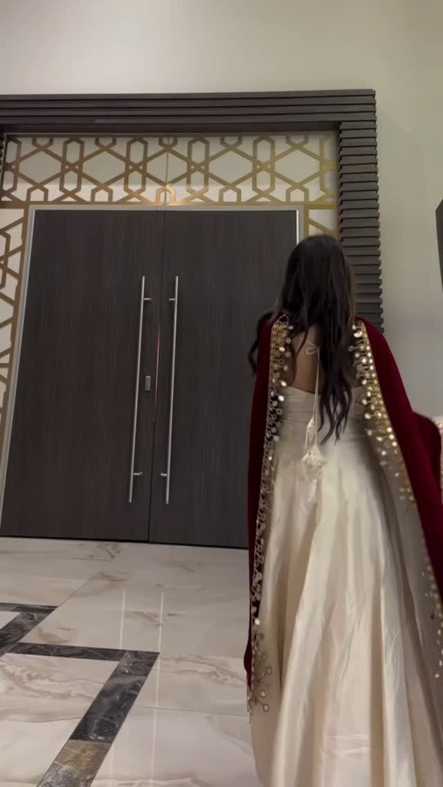 10 Wedding Themes Winter Couples Will Love in 2026 6 Person in a cream satin gown and a red velvet cape with gold sequins.