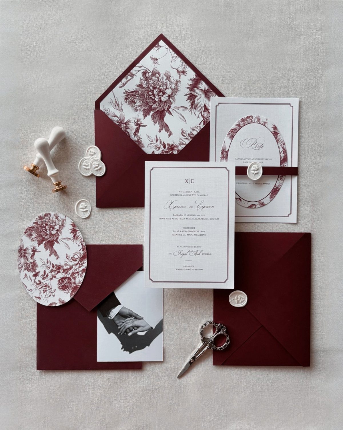 10 Wedding Themes Winter Couples Will Love in 2026 5 Burgundy and white wedding invitation suite with floral patterned envelopes and wax seal tools.